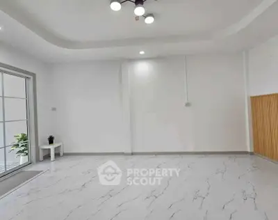 Spacious modern living room with marble flooring and elegant lighting