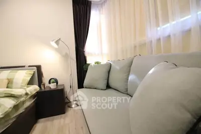 Cozy bedroom with stylish sofa and modern decor, perfect for relaxation and comfort.