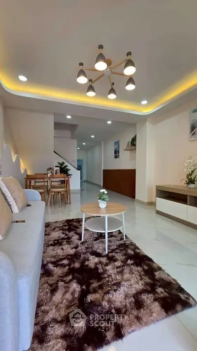 Modern living room with stylish lighting and cozy decor in a contemporary home.