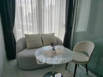 Cozy small living area with modern sofa and round table, perfect for urban apartments.