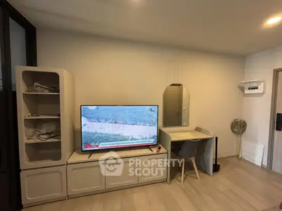 Modern living room with TV, desk, and stylish storage units