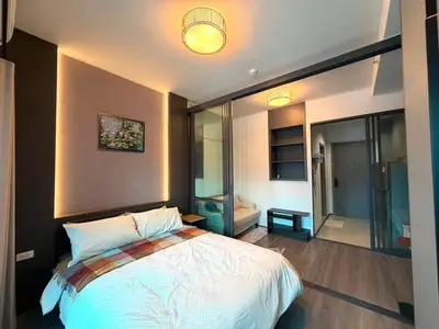 Modern bedroom with cozy lighting and stylish decor in a contemporary apartment.