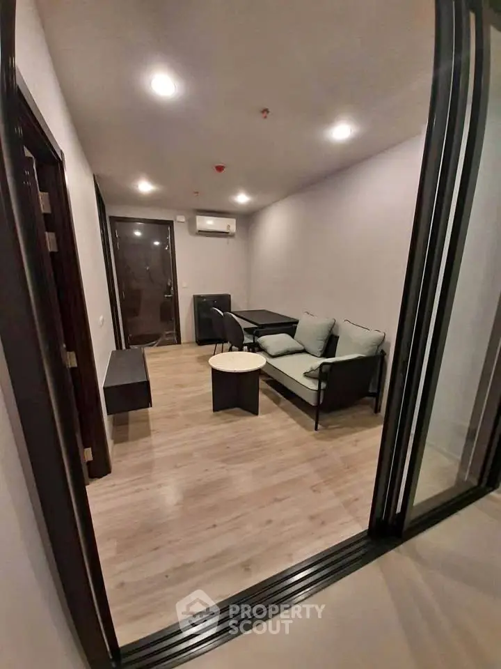 Modern living room with sleek furniture and wooden flooring, ideal for cozy gatherings.