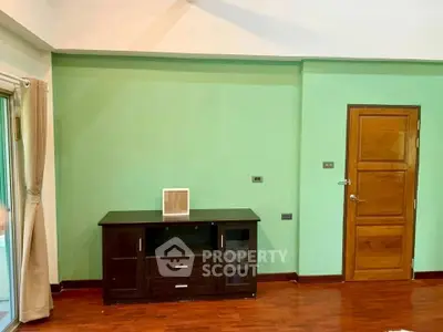 Spacious living room with wooden flooring and modern cabinet