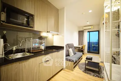 Modern studio apartment with open kitchen and cozy living area, featuring a balcony with city view.