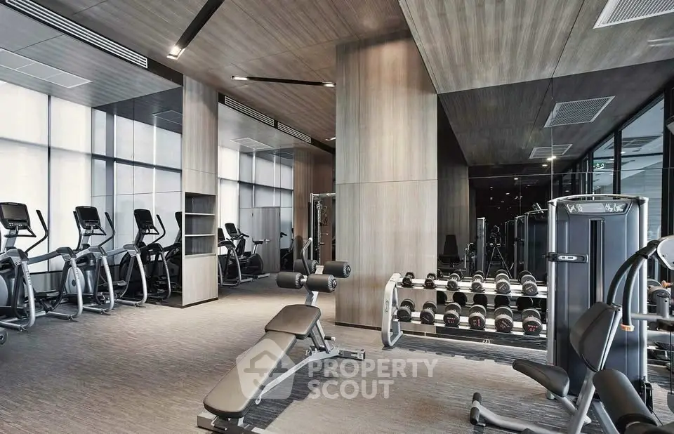 Modern gym with state-of-the-art equipment in luxury residential building.