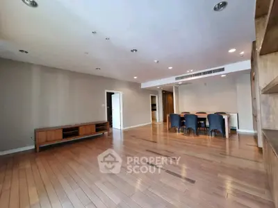 Spacious modern living room with wooden flooring and elegant dining area