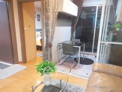 Modern apartment interior with cozy living area and dining space, featuring elegant decor and city view.