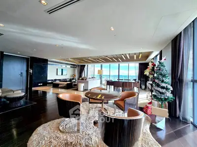 Luxurious living room with stunning ocean view and modern decor, perfect for entertaining.