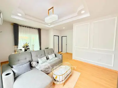 Elegant living room with modern decor and cozy seating in a bright, spacious interior.