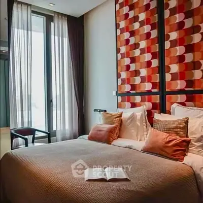 Luxurious bedroom with modern decor and large windows for natural light.