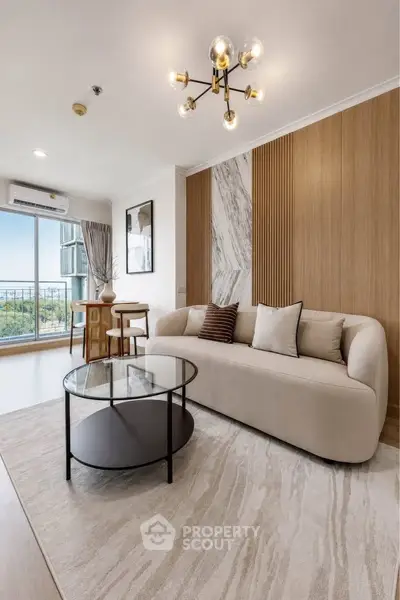 Modern living room with elegant decor, large windows, and stylish furniture offering a cozy and inviting atmosphere.