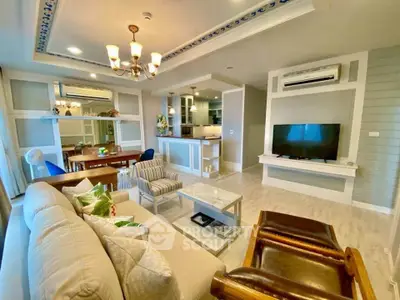 Spacious living room with modern decor and open kitchen layout