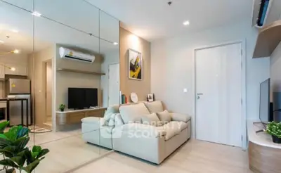 Modern living room with mirrored wall and cozy beige sofa in stylish apartment.
