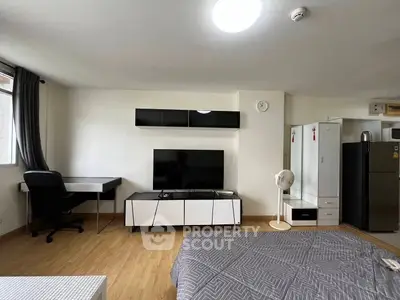 Spacious studio apartment with modern furnishings and natural light.
