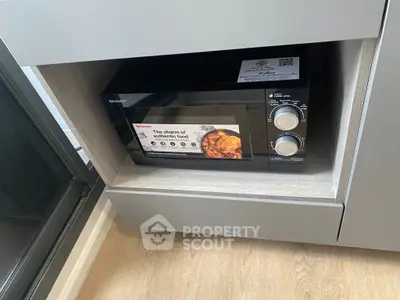 Modern kitchen with built-in microwave oven and sleek cabinetry