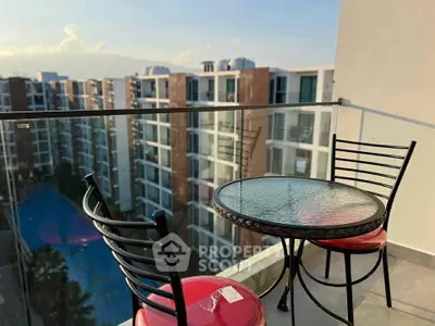 Charming balcony with glass railing and city view, perfect for relaxing outdoors.