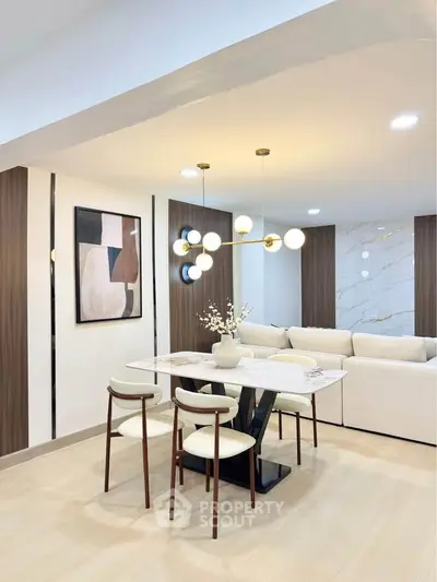 Modern dining area with elegant lighting and stylish decor in a contemporary open-plan living space.