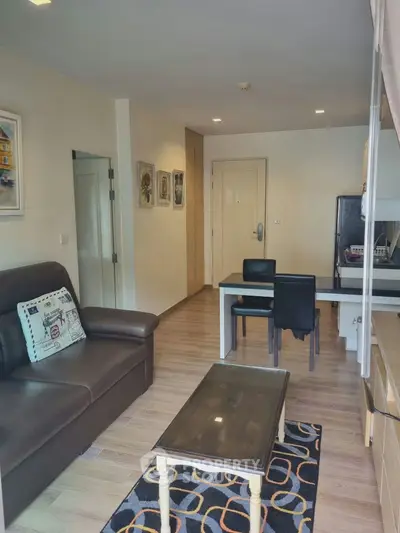 Cozy living room with modern furniture and stylish decor in a well-lit apartment.