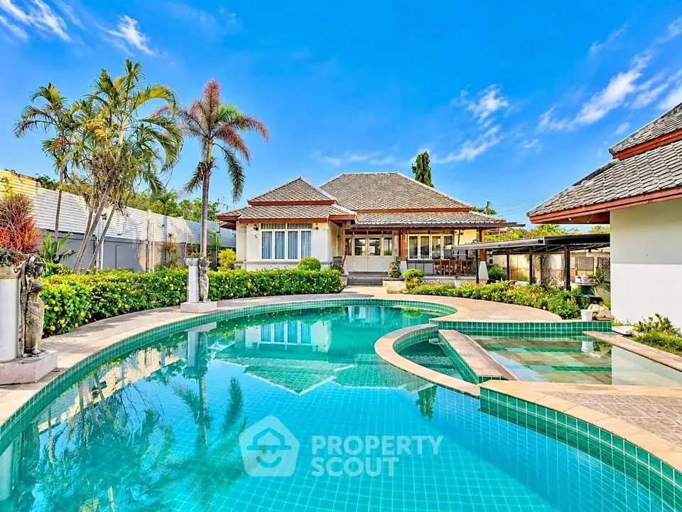 Luxurious villa with stunning pool and lush garden, perfect for tropical living.