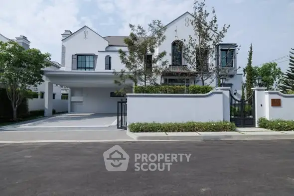 Elegant modern house with spacious driveway and lush greenery