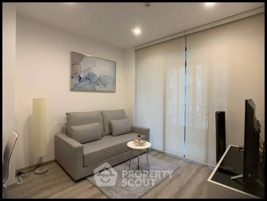 Modern living room with sleek gray sofa and stylish decor