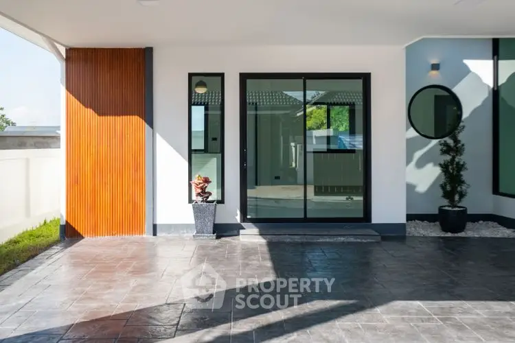 Modern home entrance with sleek design and spacious patio area