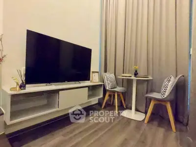 Modern living room with sleek TV setup and cozy seating area, perfect for relaxation and entertainment.
