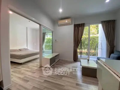 Modern apartment interior with bedroom and living room, featuring large windows and stylish decor.