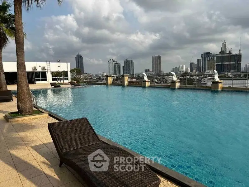 Luxurious rooftop pool with stunning city skyline views, perfect for relaxation and leisure in urban living.