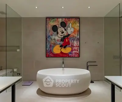 Luxurious bathroom with modern freestanding tub and artistic wall decor