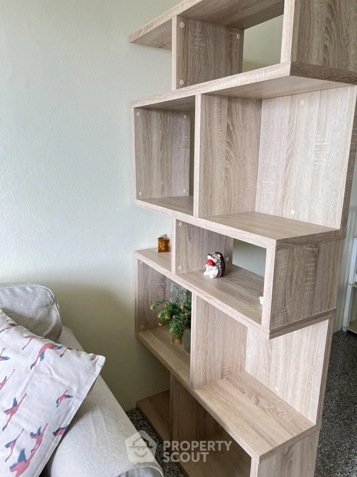 Modern living room with stylish wooden bookshelf and cozy sofa