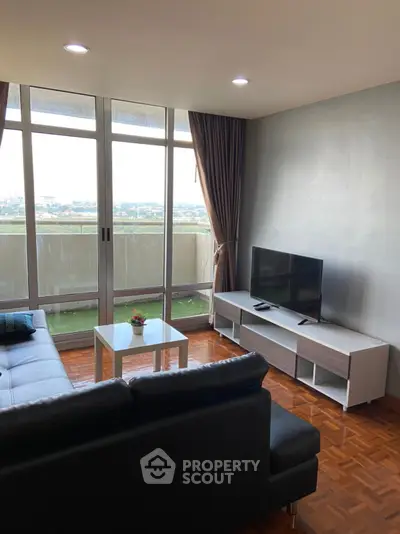 Modern living room with large windows and balcony view