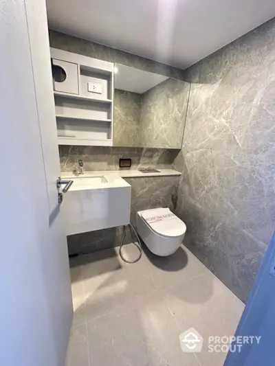 Modern bathroom with sleek design and wall-mounted toilet in luxury apartment