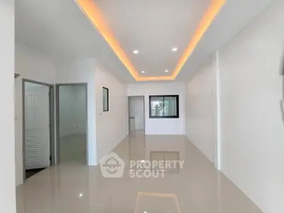 Spacious modern interior with sleek lighting and glossy tiled floors, perfect for customization.