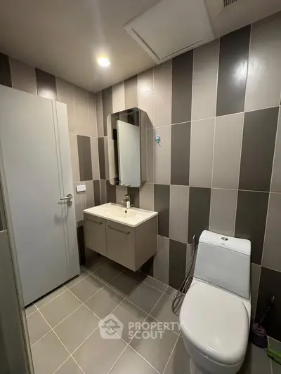 Modern bathroom with sleek design and contemporary fixtures in a stylish apartment.