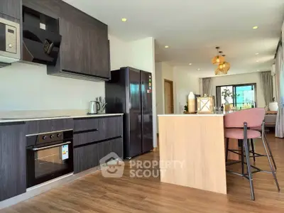 Modern open kitchen with sleek appliances and stylish dining area in a contemporary home.
