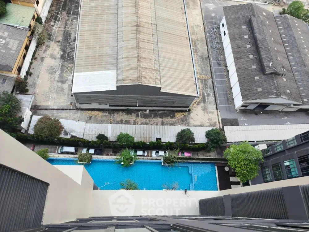 Stunning aerial view of urban swimming pool and surrounding buildings, perfect for modern city living.