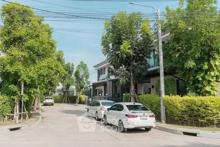 Charming suburban street with modern homes and lush greenery, ideal for family living.