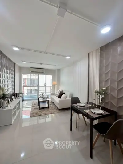 Modern living room with stylish decor and balcony access in a contemporary apartment.