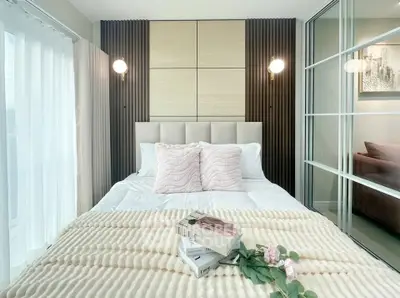 Elegant bedroom with modern decor and cozy bedding in a stylish apartment.