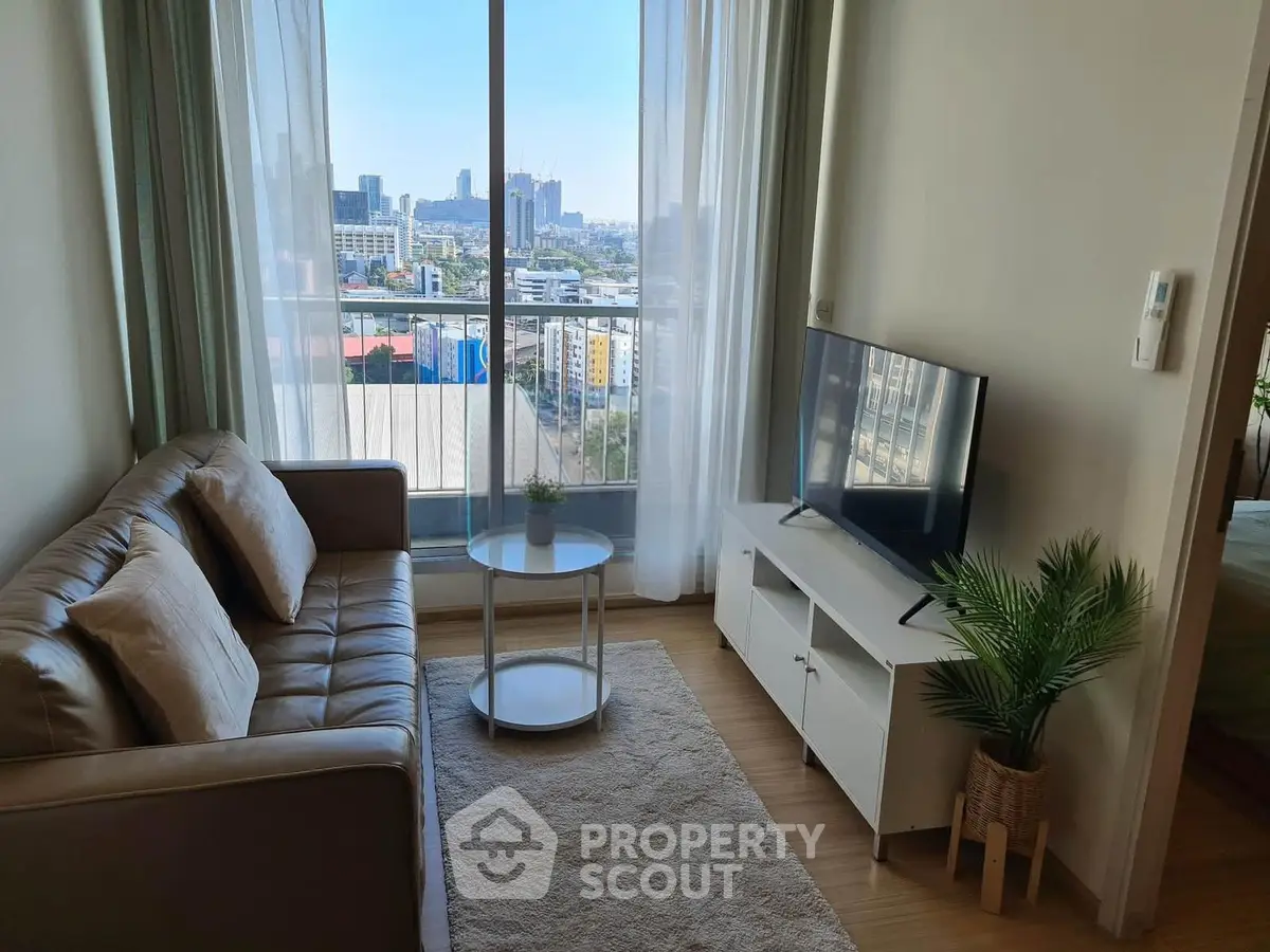 Modern living room with city view, cozy sofa, and sleek TV setup in a high-rise apartment.