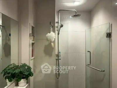 Modern bathroom with glass shower and elegant fixtures
