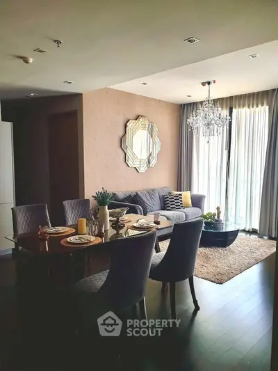 Elegant living room with dining area, stylish decor, and large windows for natural light.