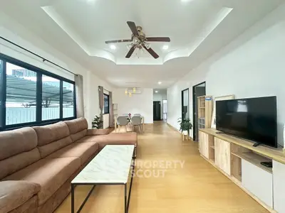 Spacious modern living room with elegant ceiling fan and cozy sectional sofa
