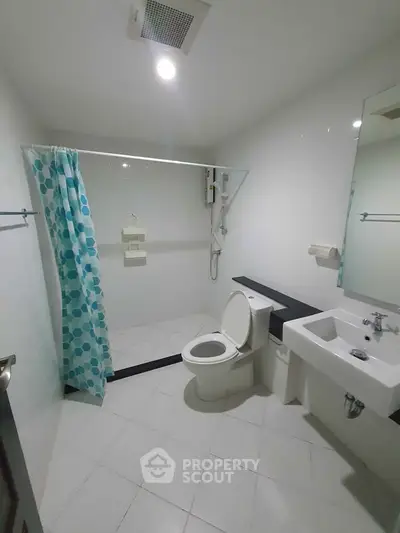 Modern bathroom with shower, toilet, and sink in minimalist design