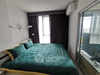 Cozy bedroom with large window and modern decor in a stylish apartment.