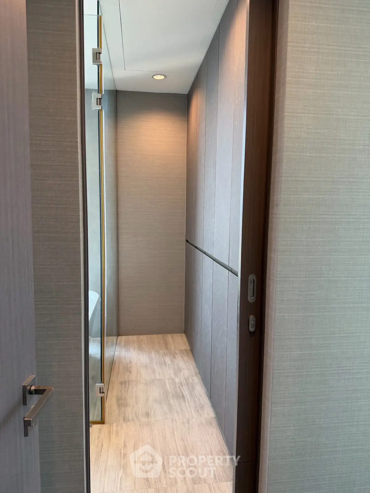 Modern hallway with sleek wooden flooring and minimalist design