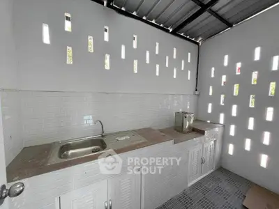 Modern outdoor kitchen with sleek design and ample natural light