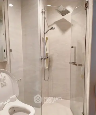 Modern bathroom with glass shower enclosure and sleek fixtures